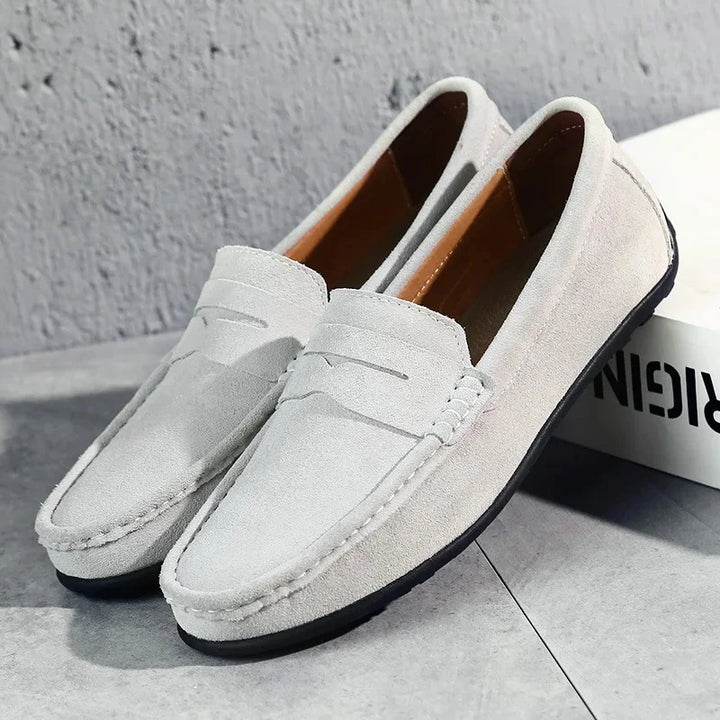 Modern interpretation of men's suede penny loafers, blending classic style with comfort.