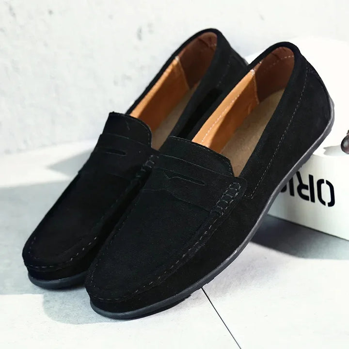 Versatile men's suede loafers in a muted olive green, ideal for smart casual ensembles.