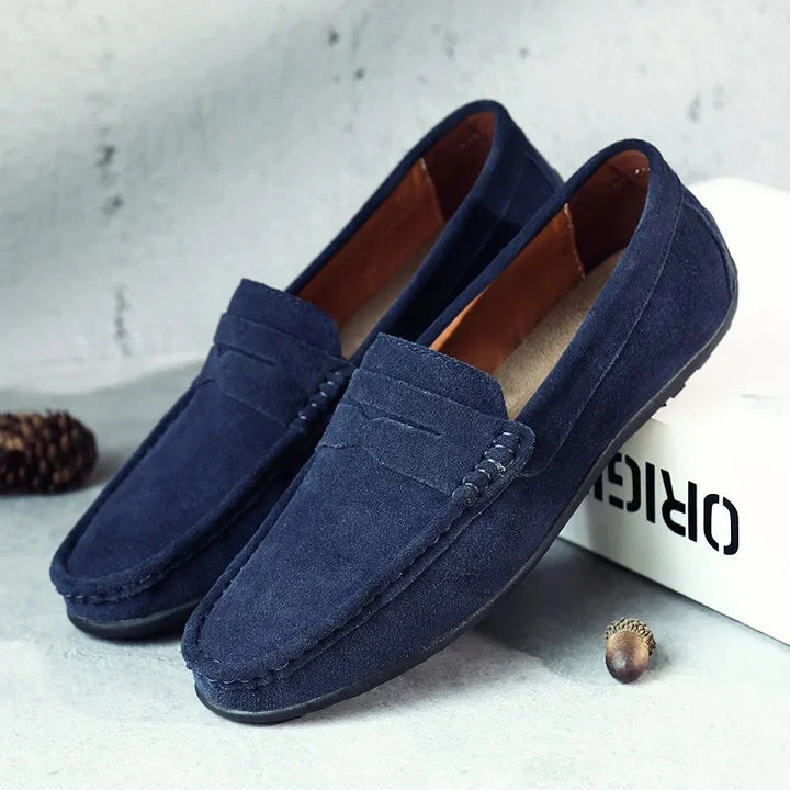 Full view of men's dark grey suede slip-on loafers, showcasing their refined design.