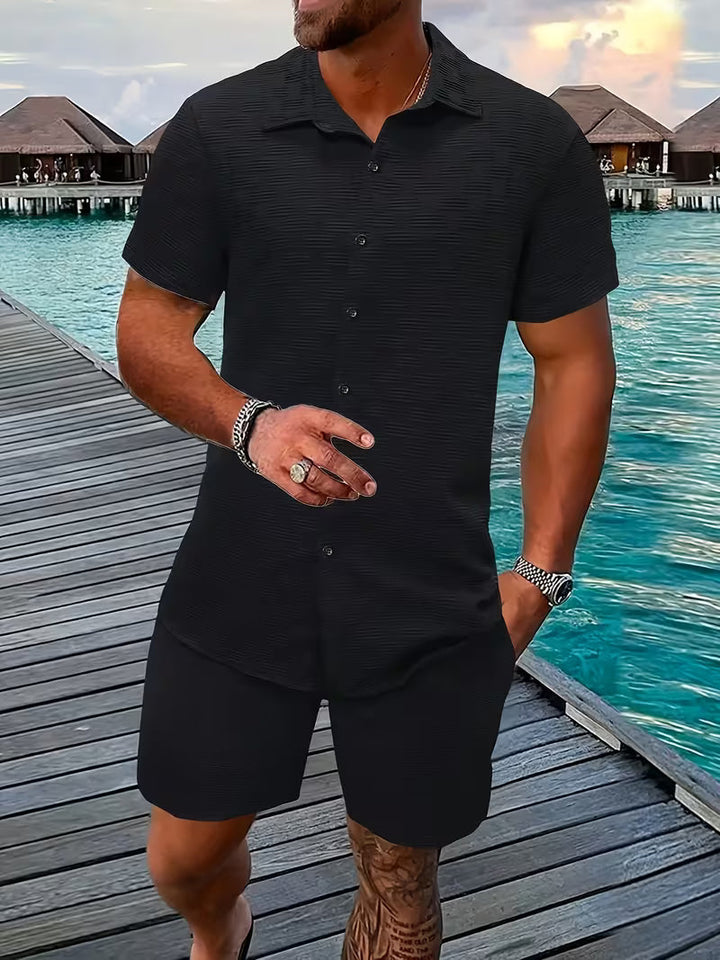 Comfortable men's two-piece summer outfit featuring a button shirt & matching shorts. Ideal for warm weather.