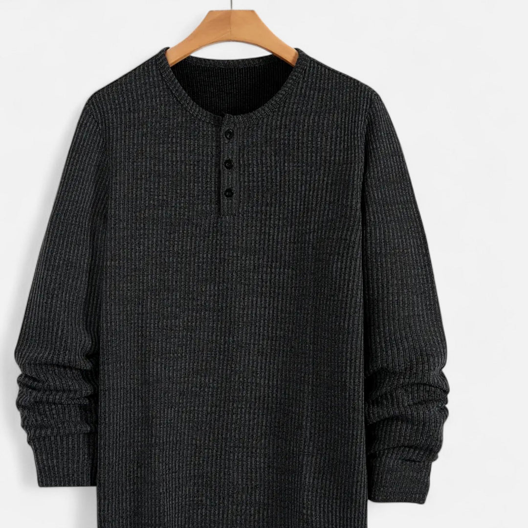 Close-up of men's cable-knit henley sweater, showcasing texture & button placket. Classic regular fit knitwear.