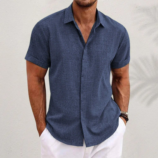 Close-up of a men's classic collar short-sleeve summer shirt. Detail on fabric & button-up design. Holiday wear.