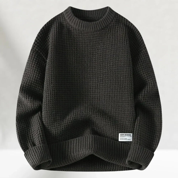Close-up of a soft, long-sleeve men's pullover sweater with a ribbed crew neck, ideal casual wear.