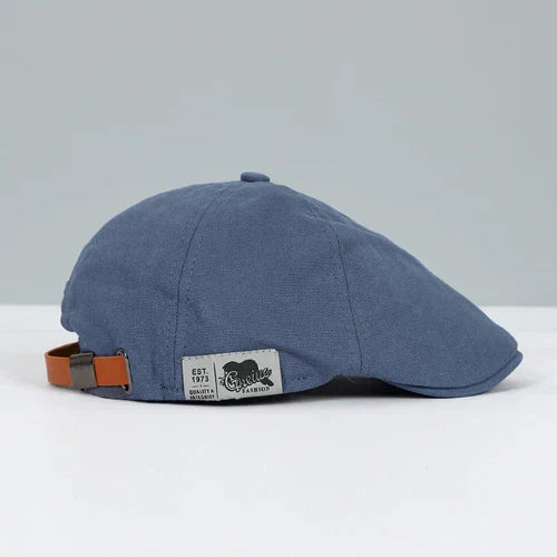 Classic men's headwear: a paneled ivy cap with a distinctive button top. Enhances casual and smart-casual styles.