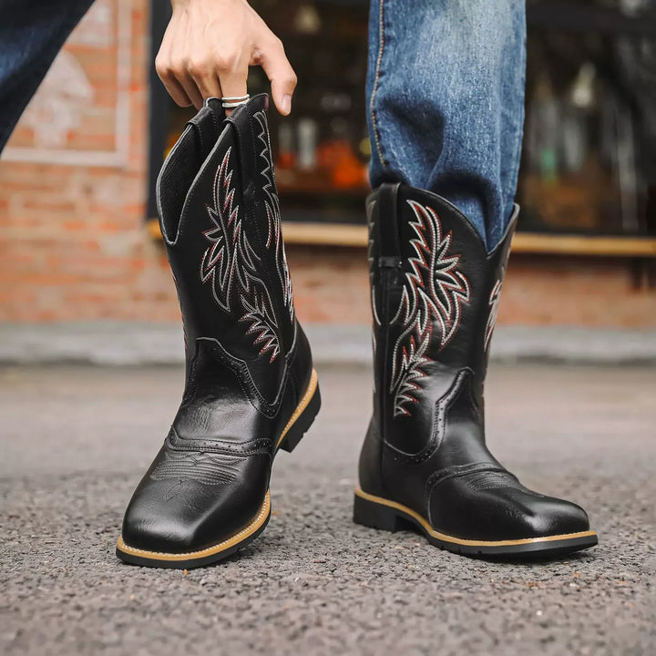 Close-up of detailed embroidery on men's classic leather western boots