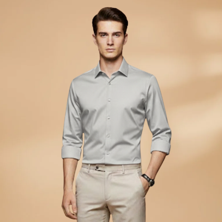 Stack of men's classic button-down shirts in various colors, long sleeve, collared style.