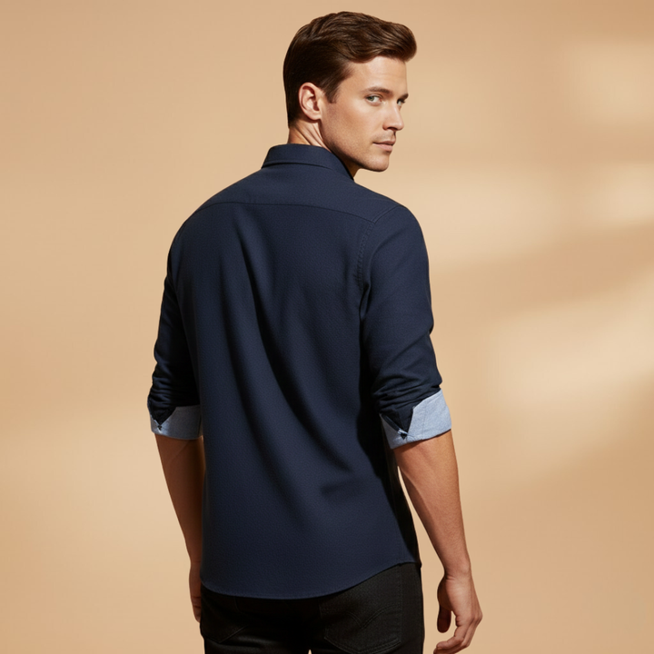 Close-up of the crisp collar on a men's classic long sleeve button-up shirt, showcasing its structured and formal design.