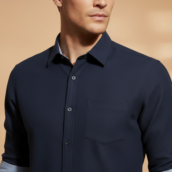 Man in a classic long sleeve button-up shirt, styled formally for office wear, showcasing its structured & professional look.