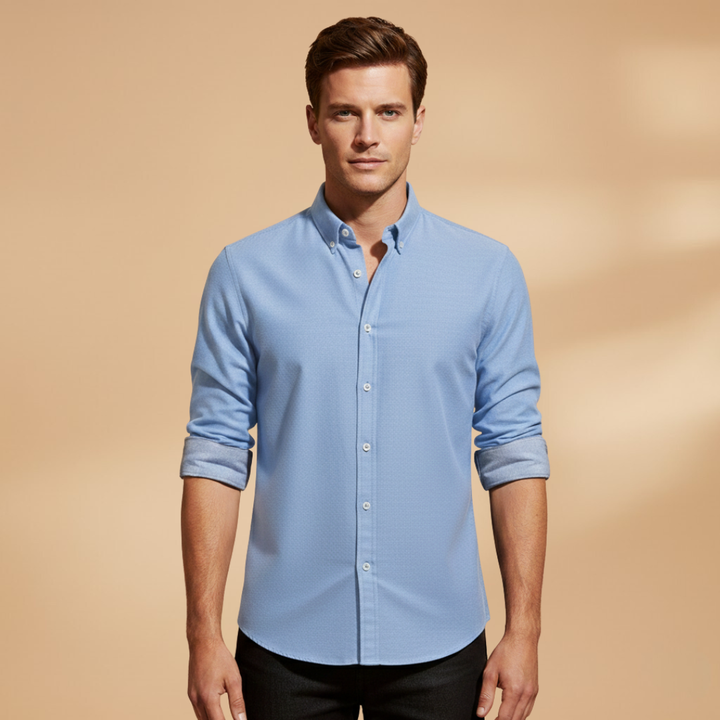 Textured fabric of a men's classic long sleeve button-up shirt, featuring a timeless structured design for versatile wear.