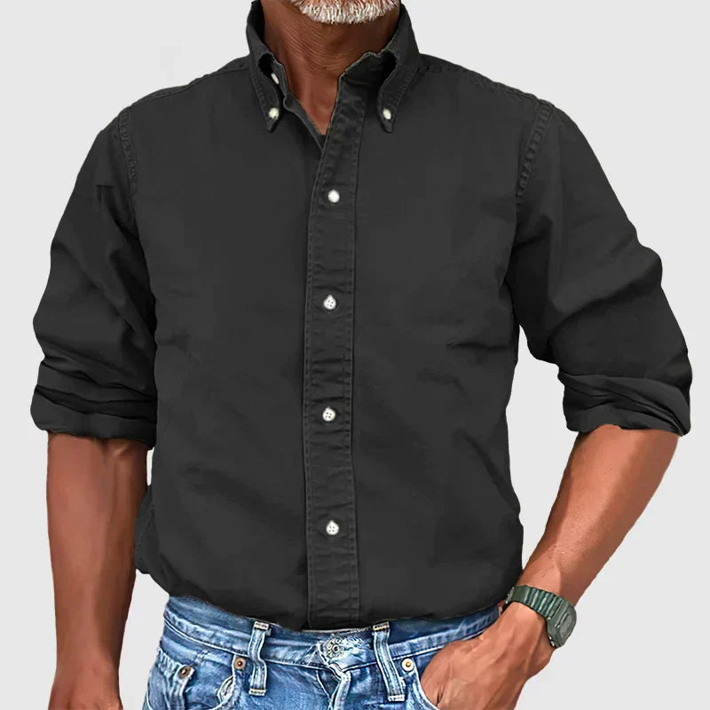 Detailed view of the buttons and stitching on a men's classic long-sleeve collared shirt.