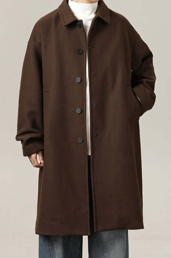 Men's classic oversized black winter coat, ideal for stylish layering, comfort, and warmth. Timeless menswear.