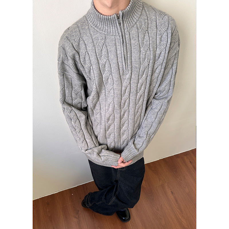 Warm men's cable knit quarter-zip pullover sweater, featuring a stylish mock neck and ribbed collar.