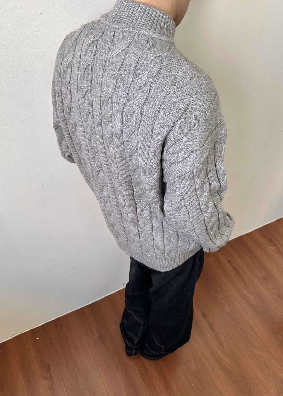 Casual men's quarter-zip cable knit sweater, a timeless piece of knitwear for cool weather and fall fashion.