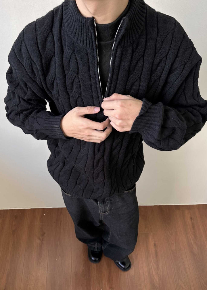 Cozy men's quarter-zip cable knit sweater, ideal for winter wear, featuring a warm mock neck and ribbed collar.