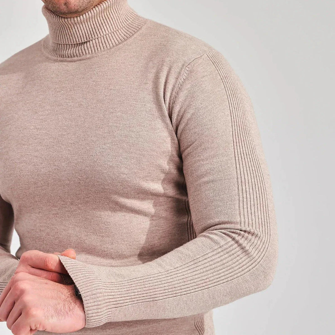Detailed shot of the comfortable knit fabric of a men's roll neck jumper, perfect for autumn outfits.