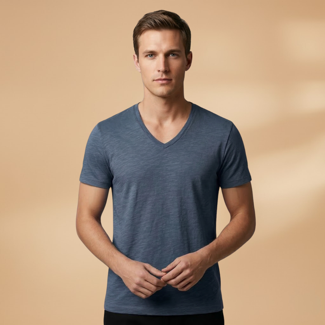 Stack of plain men's short sleeve summer t-shirts, essential comfortable tees for warm weather casual wear.