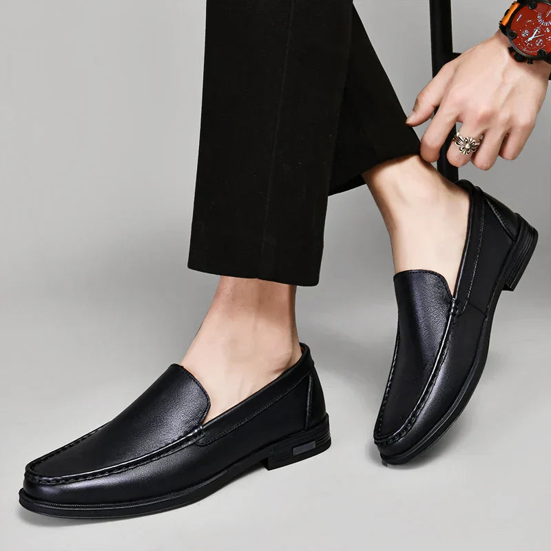 Pair of black men's classic loafers, essential slip-on shoes for versatile styling.