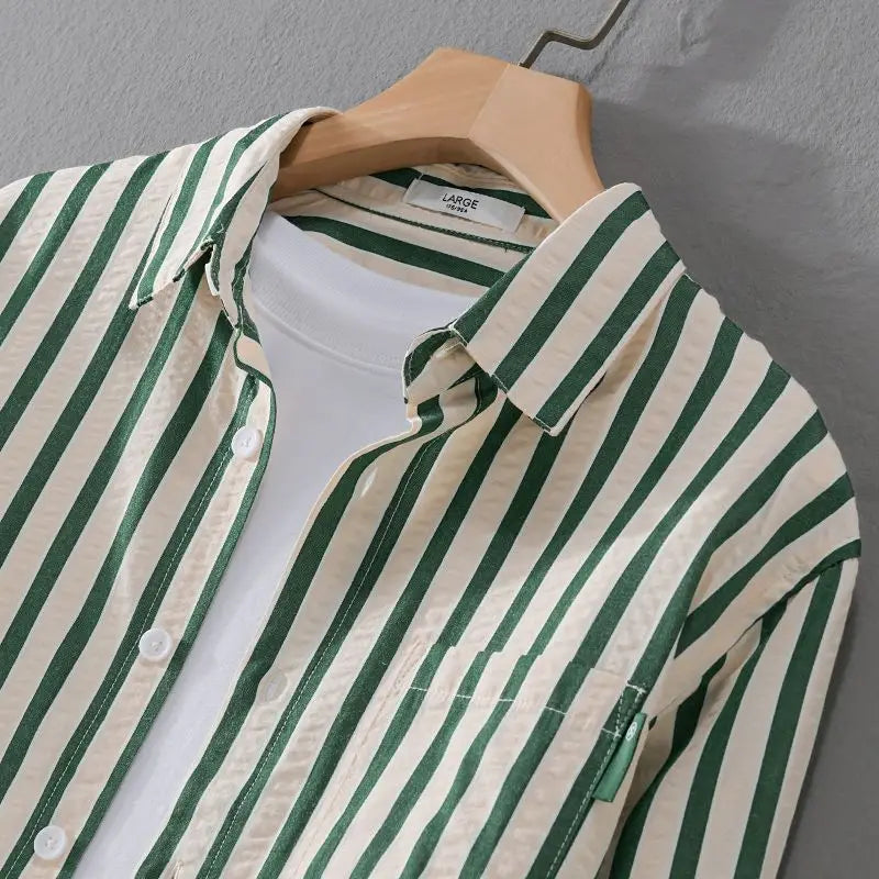 Close-up of a men's timeless striped long sleeve button-down shirt with a crisp collar and buttons.