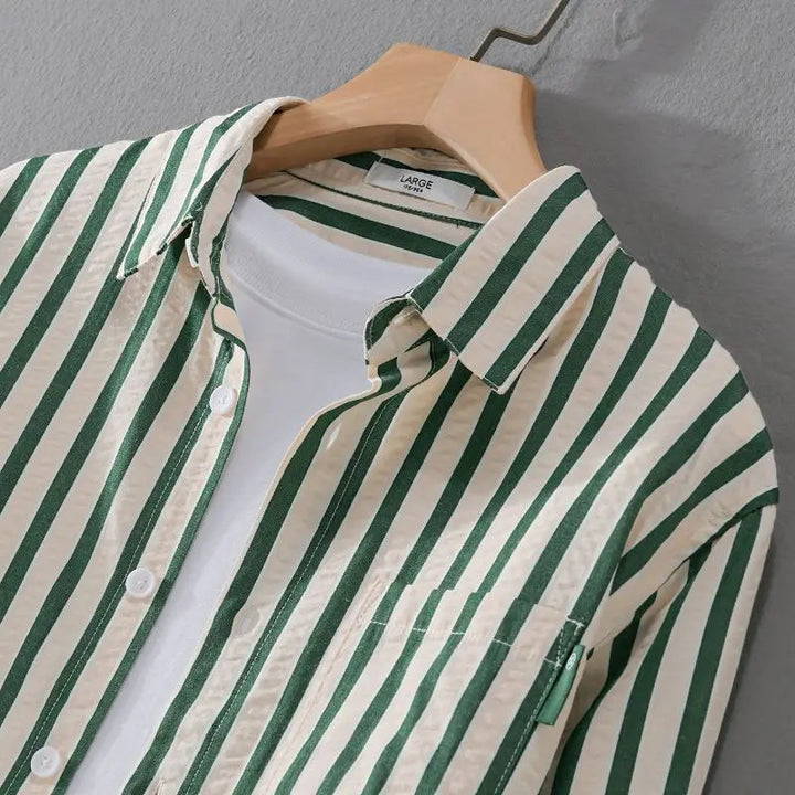 Close-up of a men's timeless striped long sleeve button-down shirt with a crisp collar and buttons.