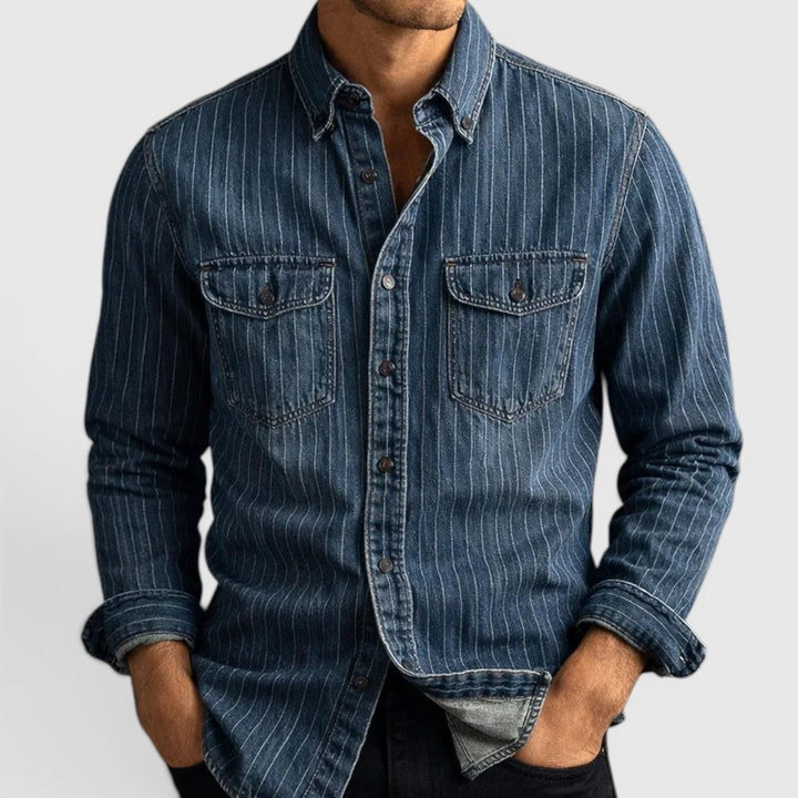 Close-up of men's blue & black striped long sleeve shirt fabric, highlighting classic button-up design.