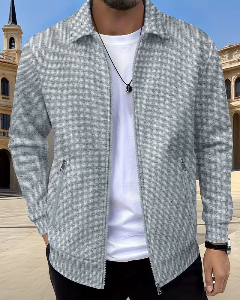 Close-up of men's textured athletic jacket showing classic fabric and stylish details. Ideal for sporty fashion.