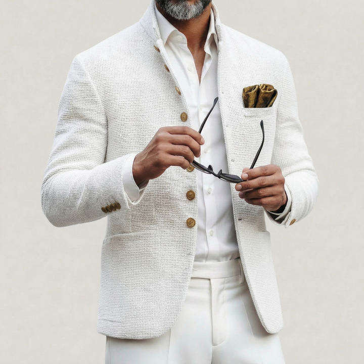 Close-up of a men's white single-breasted blazer, showing modern tailored fit and notched lapels. Business casual attire.