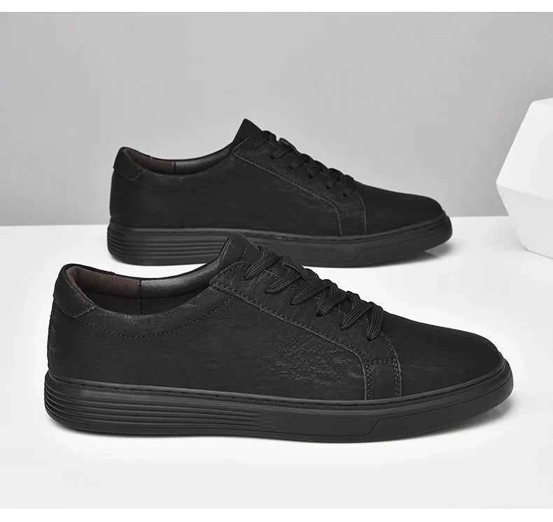 Frontal view of men's classic summer trainers, low-top and lace-up design with clear contrast stitching.