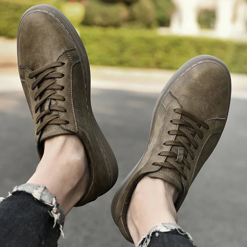 Close-up on the intricate contrast stitching of classic men's summer trainers, highlighting quality craftsmanship.