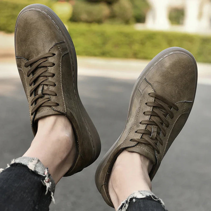 Close-up on the intricate contrast stitching of classic men's summer trainers, highlighting quality craftsmanship.