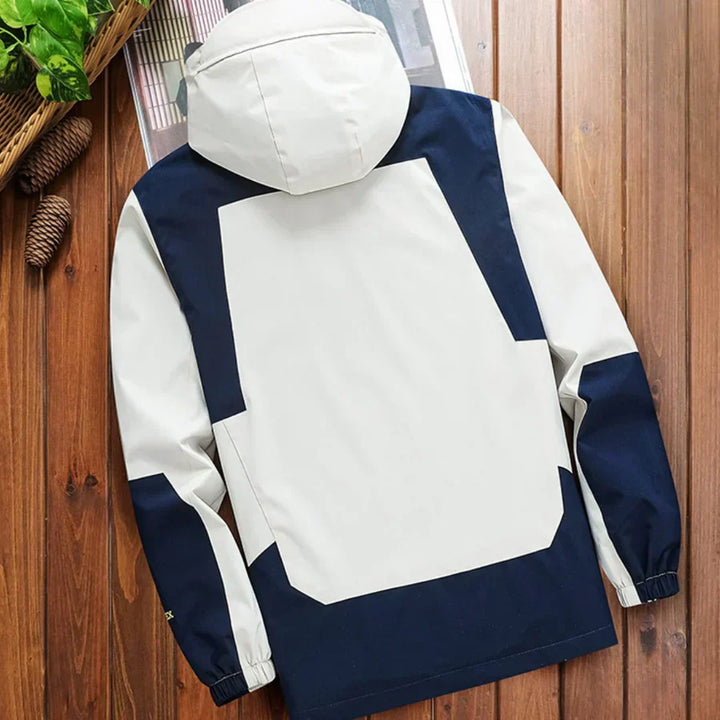 Front view of a men's casual hooded rain jacket, featuring a modern color block design & full zip.