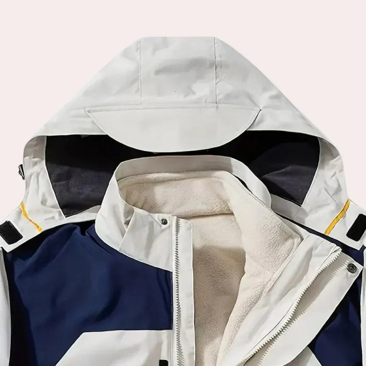 Side profile of a men's full zip hooded rain jacket, showing comfortable fit & stylish color blocking.