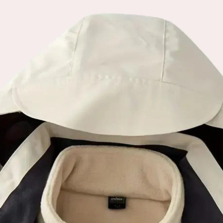 Back view of a men's casual outerwear rain jacket with a distinct color block pattern & protective hood.