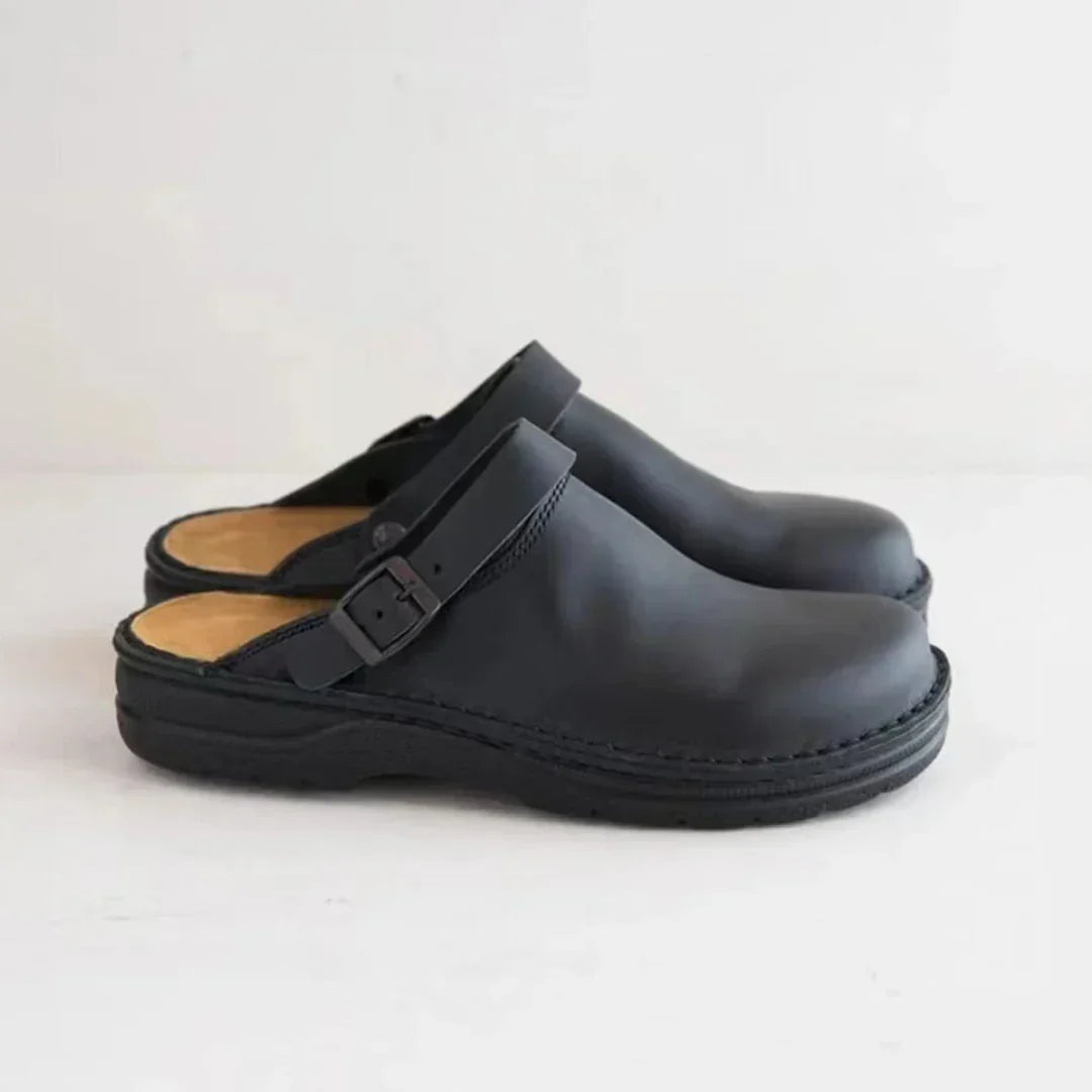 Close-up of men's slip-on clogs featuring a stylish adjustable buckle strap for a secure & comfy fit.