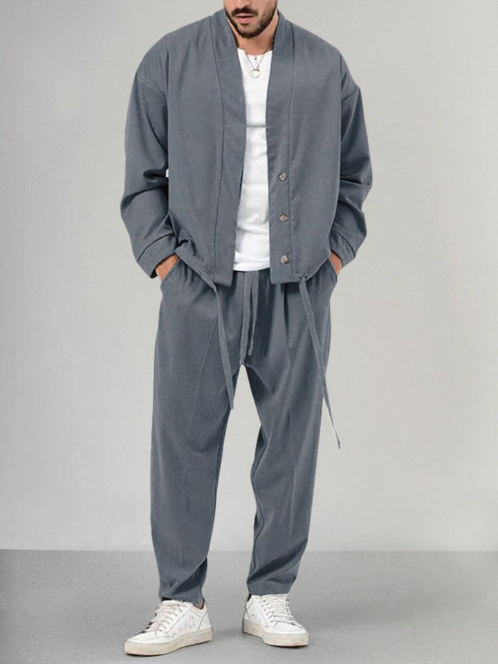 Full shot of a man wearing a cozy 2-piece men's loungewear set. Ideal for relaxing, this comfortable sweatsuit is casual.