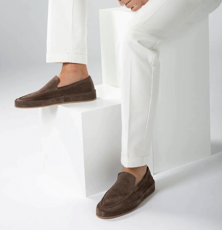 Close-up of men's comfortable loafers showing flexible sole and cushioned insole.