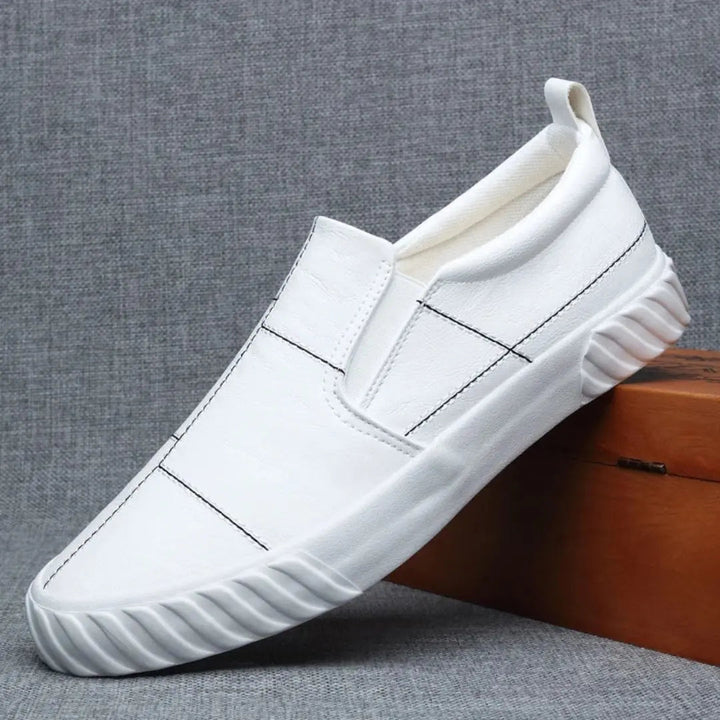 Everyday men's slip-on loafers offering comfort & style, highlighted by trendy contrast stitching. Casual footwear.
