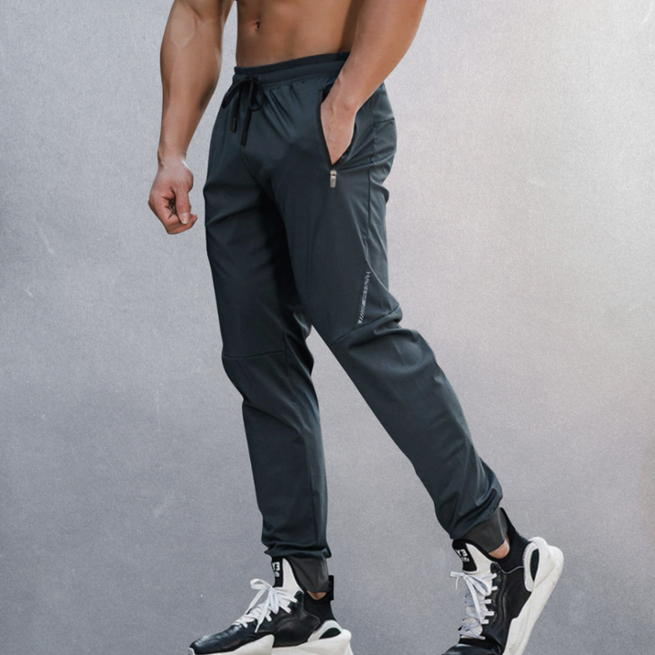 Men's comfortable sport performance pants with elastic waist for athletic activities & casual wear. Ideal for spring fashion.