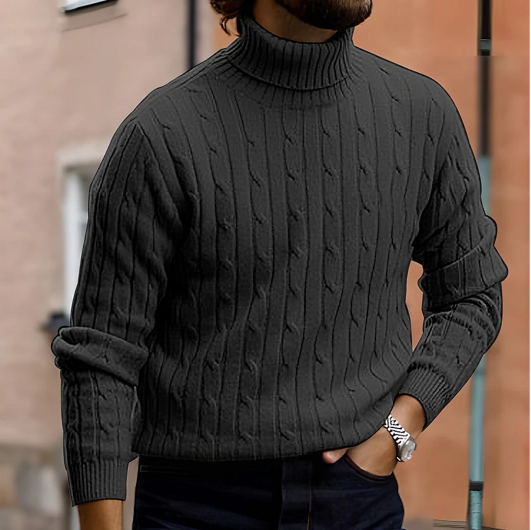 Close-up of men's long sleeve turtleneck sweater with intricate cable knit detail.