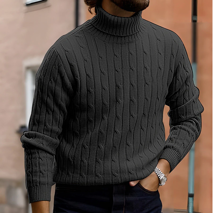 Close-up of men's long sleeve turtleneck sweater with intricate cable knit detail.