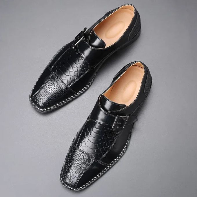 Side view of men's monk strap dress shoe with elegant crocodile embossed texture, classic style.