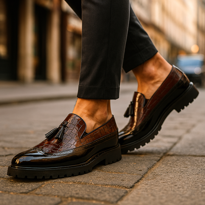 Close-up of elegant men's Dalton luxury tassel loafers, highlighting distinctive textured leather and slip-on design.