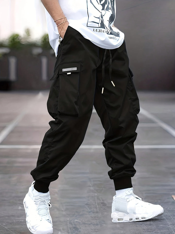 Men's drawstring cargo pants in black, offering comfort and modern style.