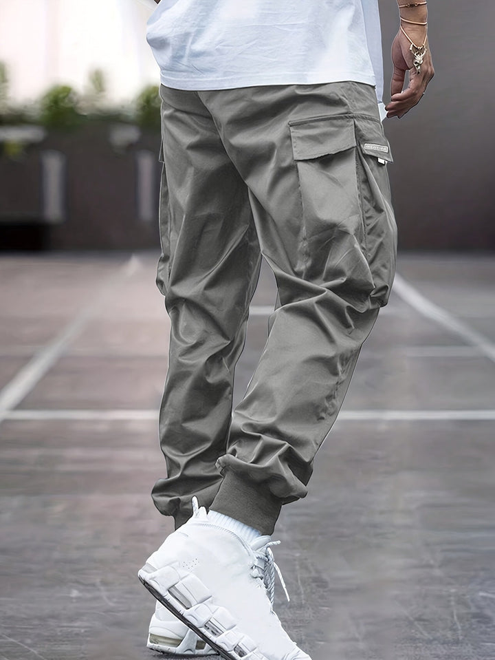 Model wearing comfortable men's utility cargo pants, perfect for everyday wear.