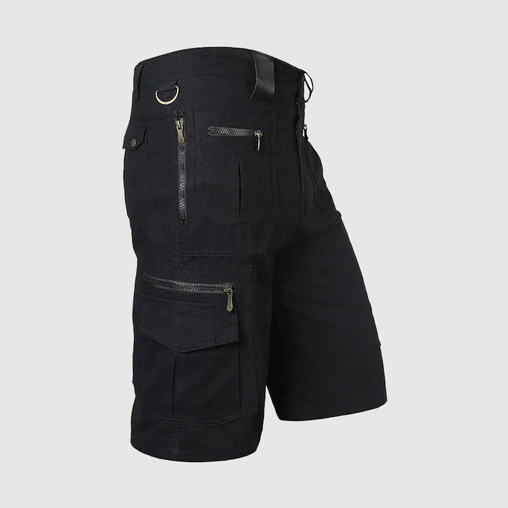 Man in durable knee-length multi-pocket cargo shorts for hiking, outdoor adventure & casual summer wear.