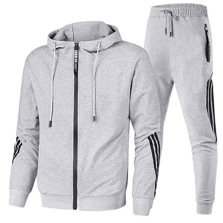 Man running in a modern men's dynamic performance tracksuit set. Perfect running suit for active men's fashion.