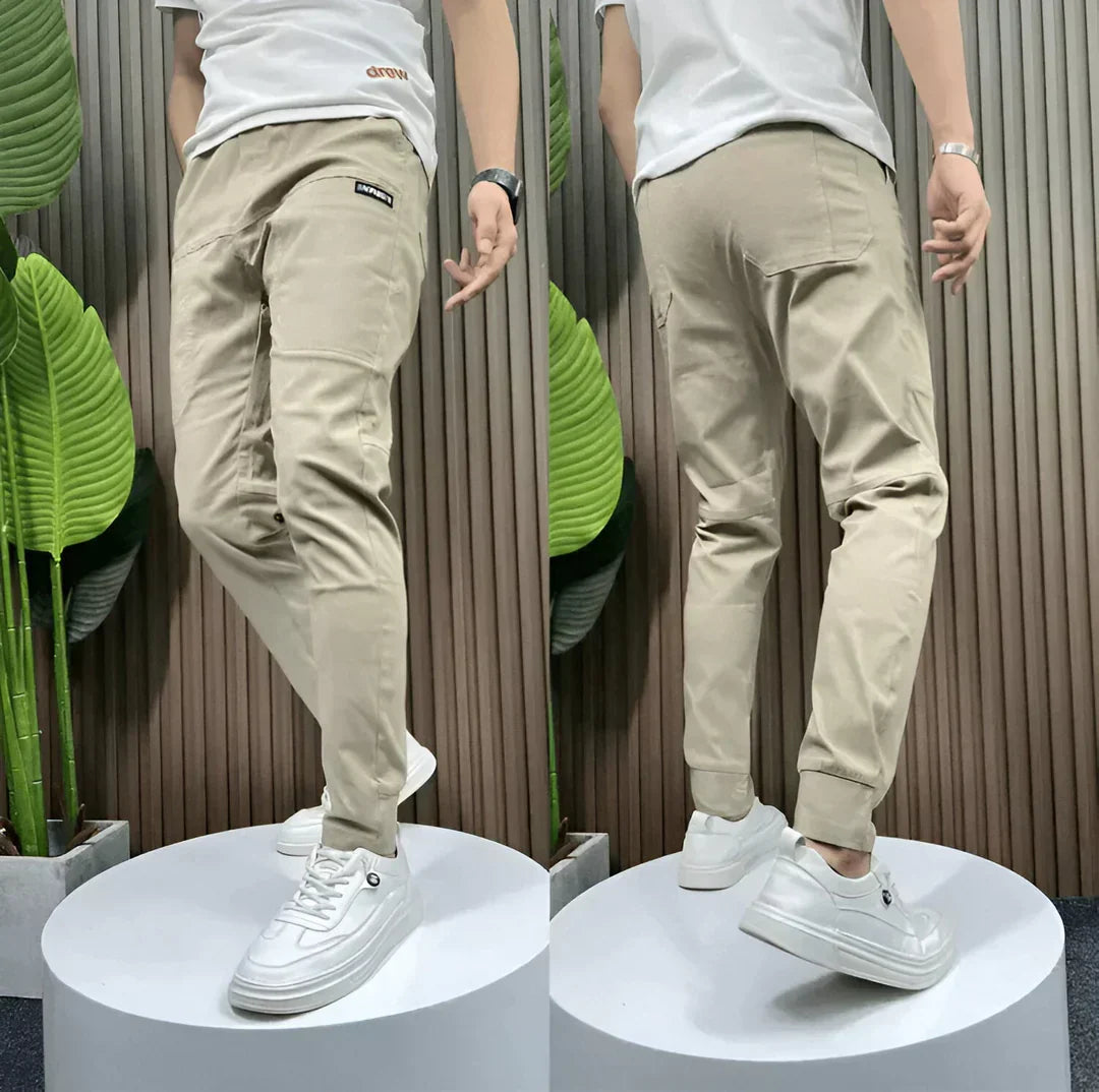 Men's elastic cargo pants, neutral color, offering comfort, stretch fit, & practical everyday style. Ideal for casual wear.