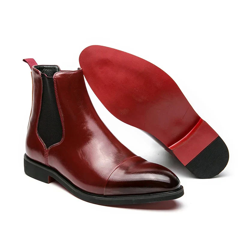 Close-up of men's brown leather slip-on boots showcasing fine stitching and smooth finish.