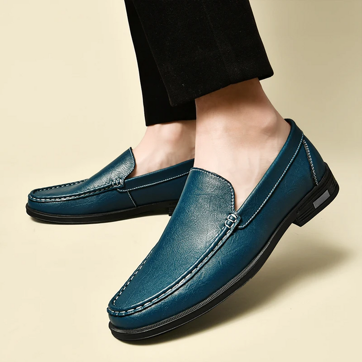 Men's elegant brown leather slip-on loafers, perfect for formal or casual refined style.