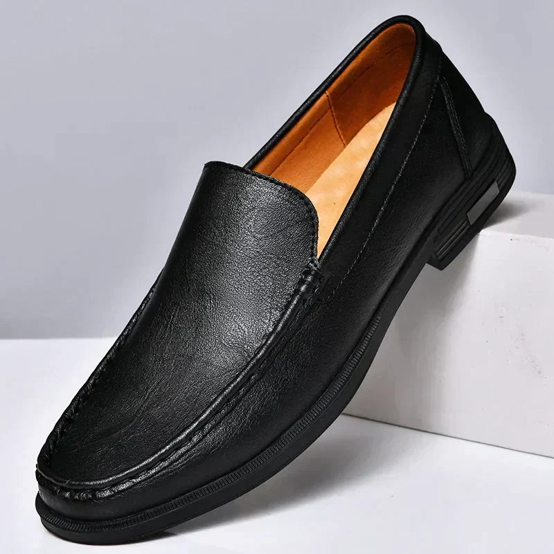 Classic men's black leather slip-on loafers with refined stitching & comfortable design for versatile wear.