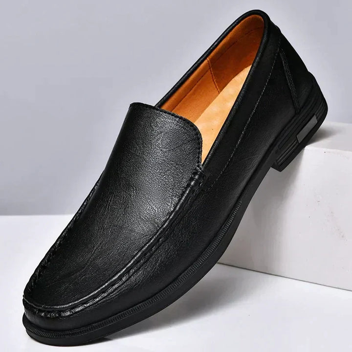 Classic men's black leather slip-on loafers with refined stitching & comfortable design for versatile wear.